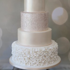 4 tier wedding cake with ruffles and sheen